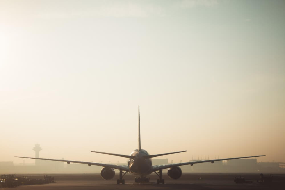 Plane-going-down-runway-at-sunset