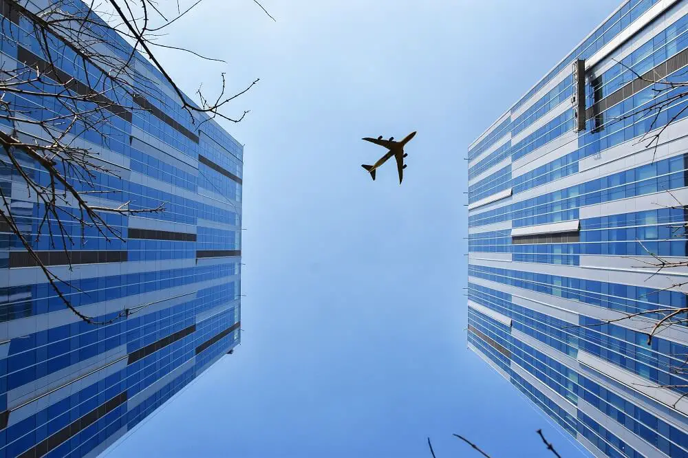 skyscrapers with plane in the middle